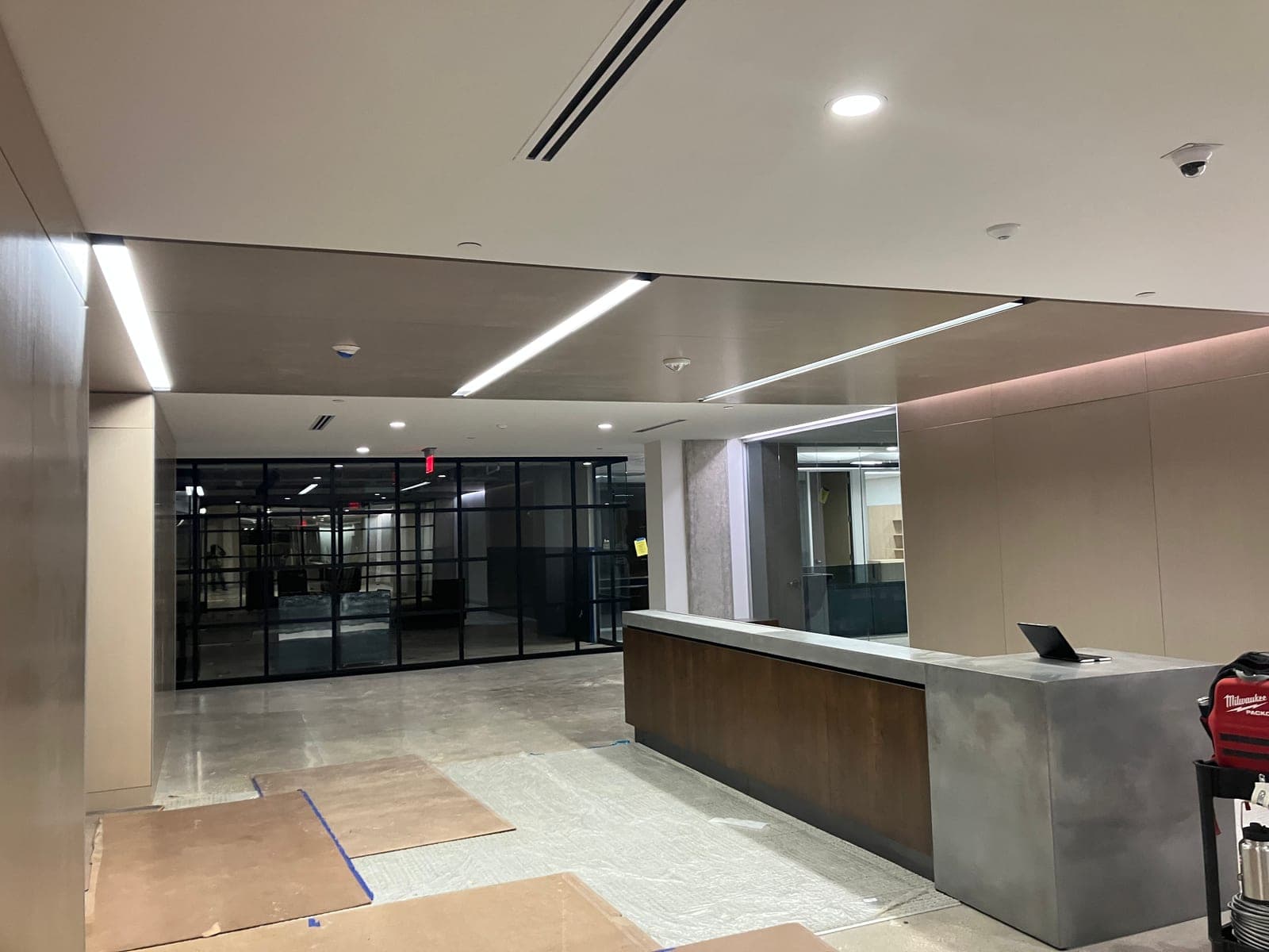 Modern commercial lobby with linear lighting and reception desk
